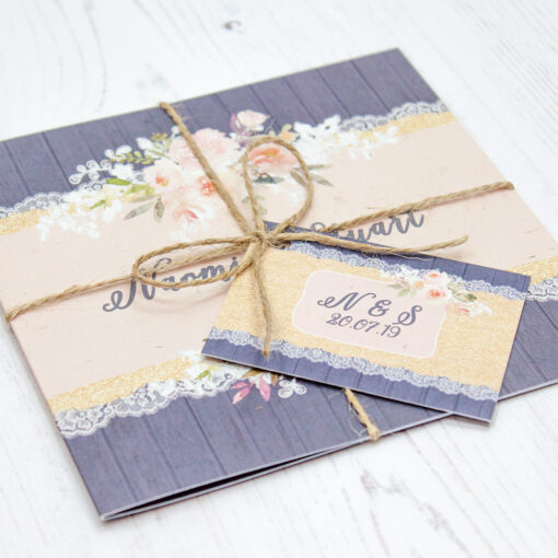 Close up of Folded Midnight Glimmer Wedding Invitations with String & Tag