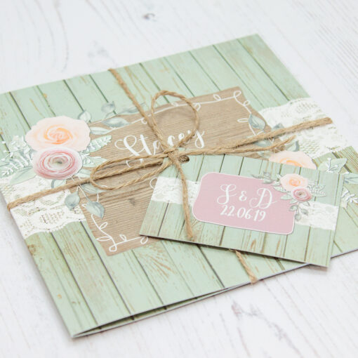Close up of Folded Ophelia Sage Wedding Invitations with String & Tag